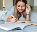 19 year old university student studying on her bed, hoping to be inderupted by phone sex